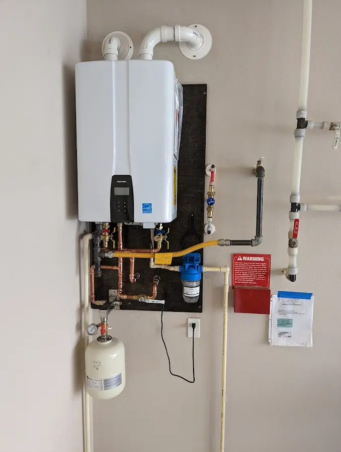 Professional plumber installing copper piping in a Columbiana home